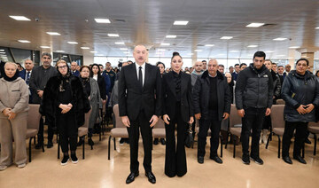 Azerbaijan's President Ilham Aliyev and his wife Mehriban Aliyeva attend a funeral ceremony.